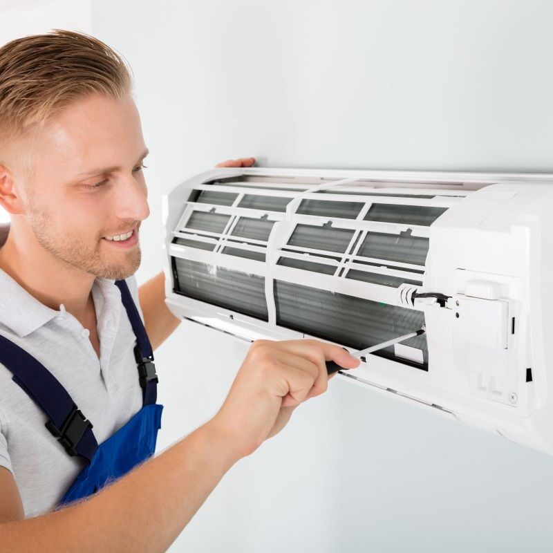 Man Helping to Maximize AC Units Lifespan in Reno, Nevada