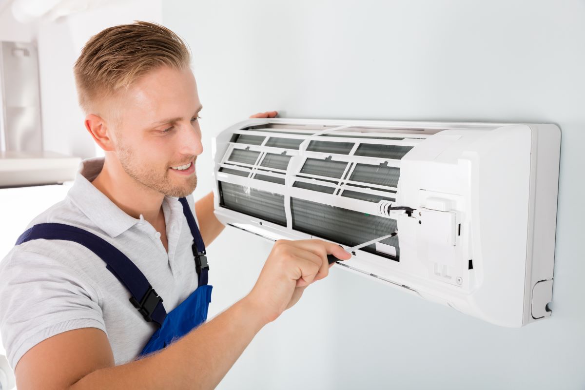 Man Helping to Maximize AC Units Lifespan in Reno, Nevada